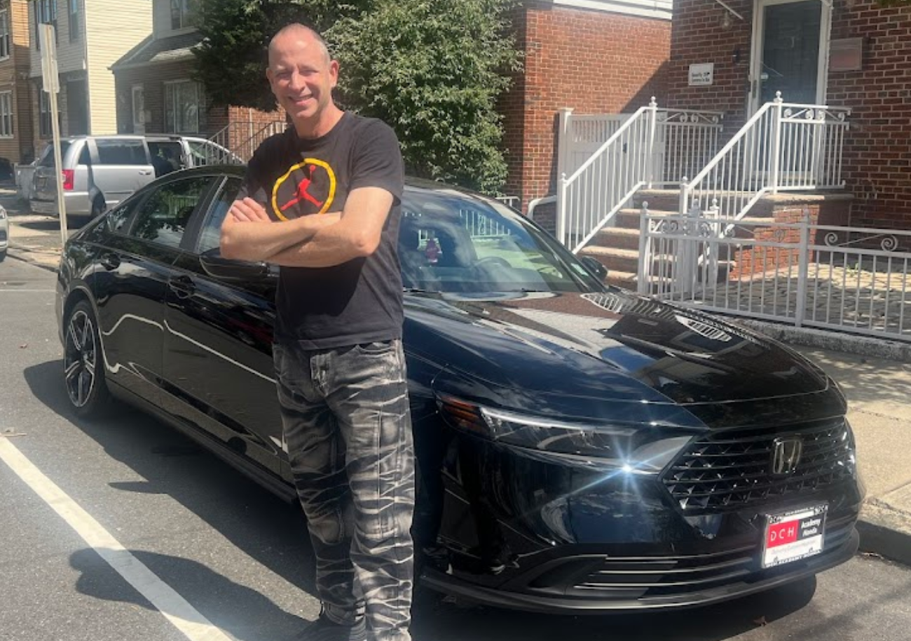 man standing next to car